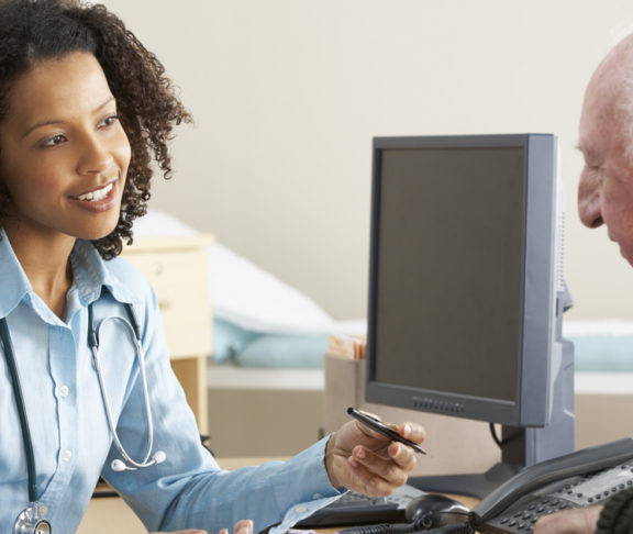 Young female Doctor with senior male patient