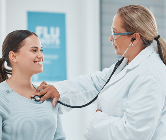 Shot of a doctor examining a patient with a stethoscope during a consultation in a clinic