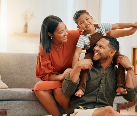 family of three relaxing in the lounge and being playful together.